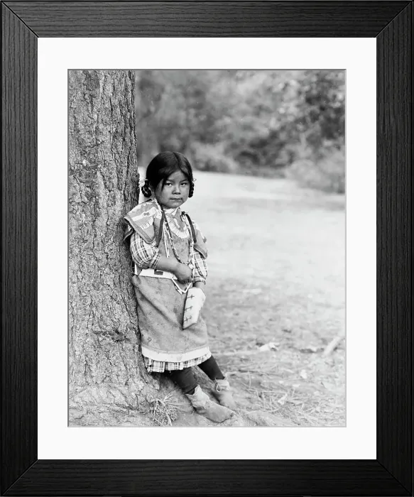 Framed Print : Innocence, an Umatilla girl, full-length portrait, standing by tree, facing slightly right, c1910. Creator: Edward Sheriff Curtis Framed Print : Innocence, an Umatilla girl, full-length portrait, standing by tree, facing slightly right, c1910. Creator: Edward Sheriff Curtis