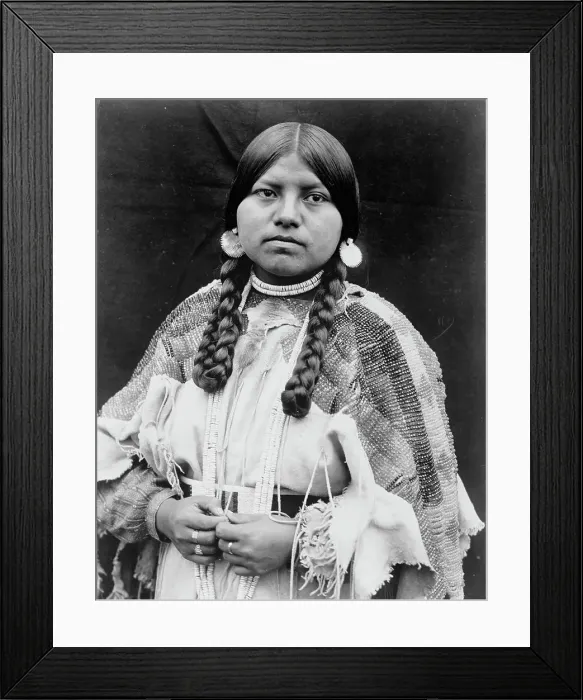 Framed Print : Cayuse woman, half-length portrait, standing, facing front, braids, shell disk earrings... c1910. Creator: Edward Sheriff Curtis