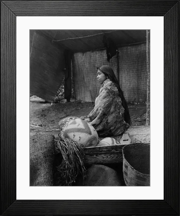 Framed Print : A Skokomish Indian chief's daughter, half-length portrait, seated on canoe, facing left, c1913. Creator: Edward Sheriff Curtis Framed Print : A Skokomish Indian chief's daughter, half-length portrait, seated on canoe, facing left, c1913. Creator: Edward Sheriff Curtis