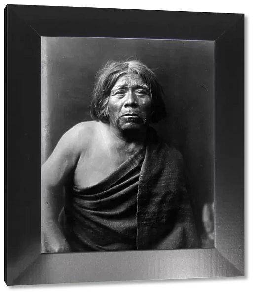 Mat Stams-Maricopa, half-length portrait, facing front, wrapped in blanket, c1907. Creator: Edward Sheriff Curtis