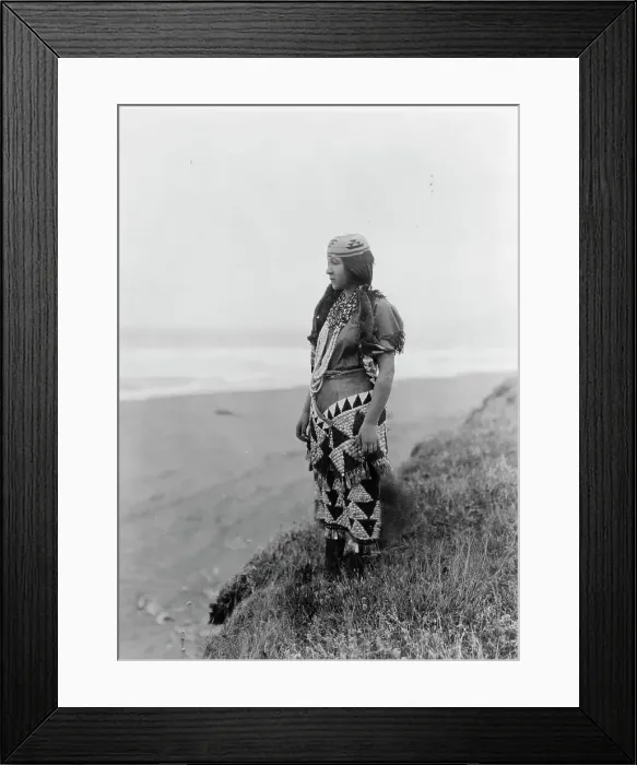 Framed Print : Woman's primitive dress-Tolowa, c1923. Creator: Edward Sheriff Curtis Framed Print : Woman's primitive dress-Tolowa, c1923. Creator: Edward Sheriff Curtis