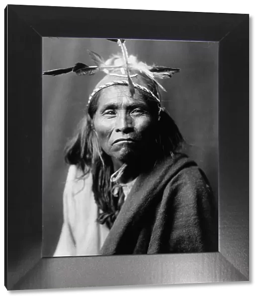 Ndee Sangochonh, Apache Indian, half-length portrait, facing front, c1906. Creator: Edward Sheriff Curtis
