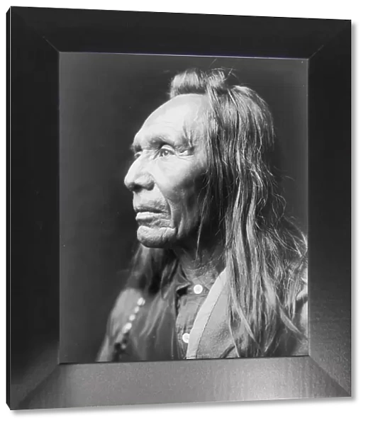 Three Eagles, a Nez Percé Indian, head-and-shoulders portrait, facing left, c1910. Creator: Edward Sheriff Curtis