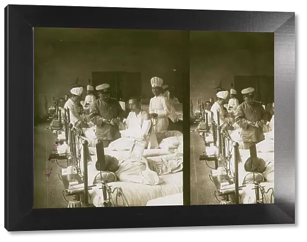 Nurses and a doctor attending wounded soldiers on a hospital ward, c1905. Creator: Underwood & Underwood. Nurses and a doctor attending wounded soldiers on a hospital ward, c1905. Creator: Underwood & Underwood