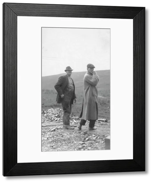 Framed Print : Two men standing near a small pile of rubble, in a field, between c1900 and 1916. Creator: Unknown