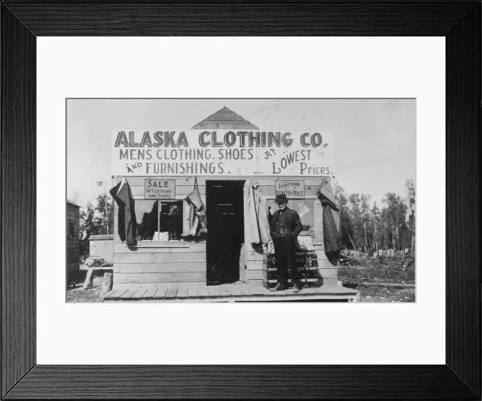 Framed Print : Man in front of Alaska Clothing Co. store, between c1900 and 1916. Creator: Unknown Framed Print : Man in front of Alaska Clothing Co. store, between c1900 and 1916. Creator: Unknown