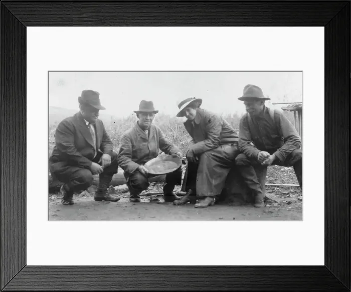 Framed Print : Group portrait of a woman and three men, crouched outside, smiling; one... between c1900 and 1916. Creator: Unknown Framed Print : Group portrait of a woman and three men, crouched outside, smiling; one... between c1900 and 1916. Creator: Unknown