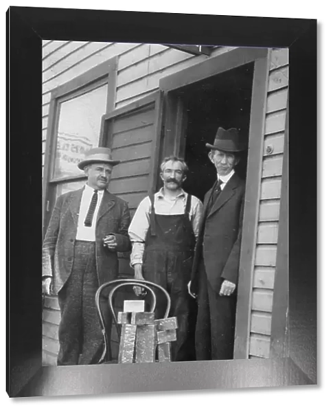 Delegate Wickersham, the assayer and Frank G. Carpenter in front of... between c1900 and 1916. Creator: Unknown