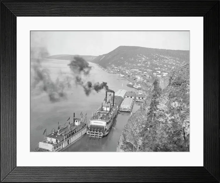 Framed Print : Riverboats distant view of town, between c1900 and 1923. Creator: Unknown Framed Print : Riverboats distant view of town, between c1900 and 1923. Creator: Unknown