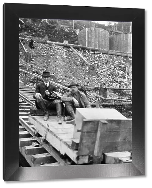 Frank G. Carpenter and man sitting on tracks, between c1900 and 1924. Creator: Unknown