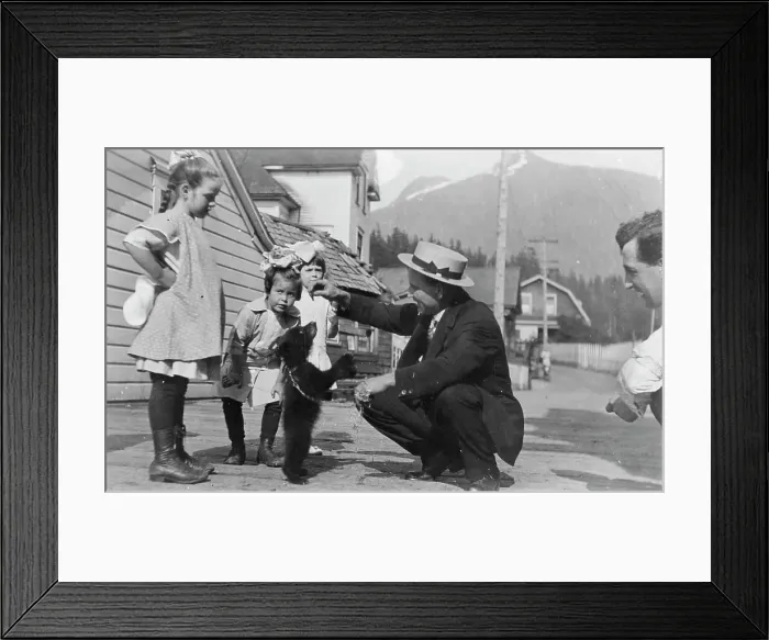 Framed Print : White people with bear cub, between c1900 and c1930. Creator: Unknown Framed Print : White people with bear cub, between c1900 and c1930. Creator: Unknown