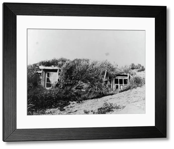 Framed Print : An Aleut house, which is a hole in the earth covered with a framework of driftwood... c1900-c1930. Creator: Unknown Framed Print : An Aleut house, which is a hole in the earth covered with a framework of driftwood... c1900-c1930. Creator: Unknown