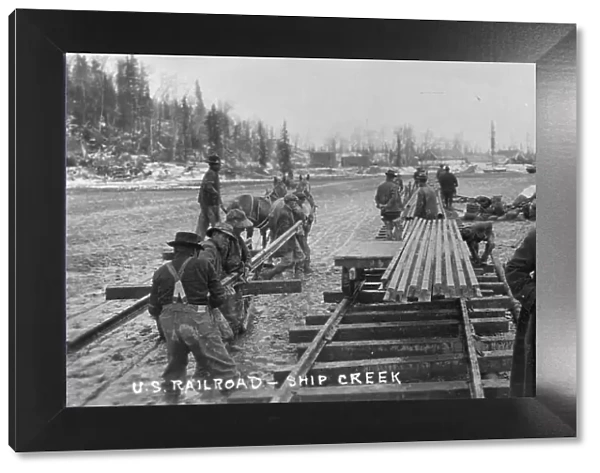 Laying first rails of new U.S. railroad at Ship Creek, between c1900 and c1930. Creator: Unknown