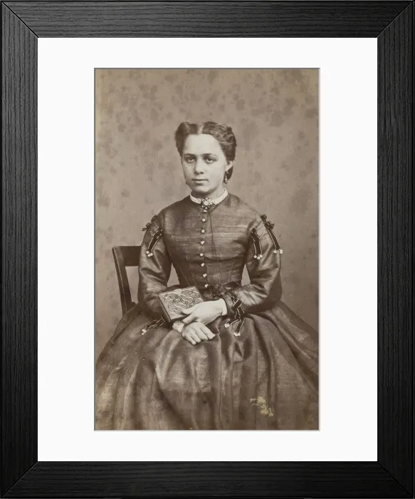 Framed Print : Business card, studio portrait of woman holding a photo album. (c1880s) Creator: Karolina Christianson Framed Print : Business card, studio portrait of woman holding a photo album. (c1880s) Creator: Karolina Christianson