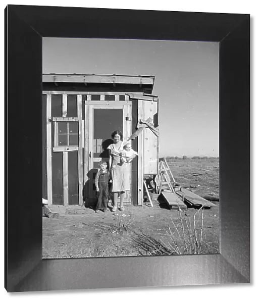 Resettled at Bosque Farms project - family of four from Taos Junction, 1935. Creator: Dorothea Lange