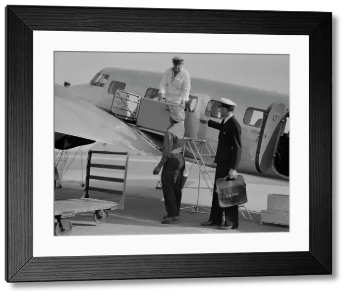 Framed Print : Unloading baggage for inspection...plane from Mexico, Glendale Airport, California, 1937. Creator: Dorothea Lange Framed Print : Unloading baggage for inspection...plane from Mexico, Glendale Airport, California, 1937. Creator: Dorothea Lange