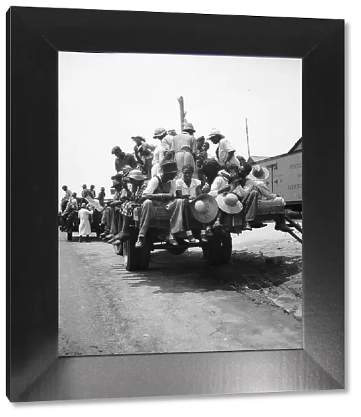 Peach pickers being driven to the orchards, Muscella, Georgia, 1936. Creator: Dorothea Lange