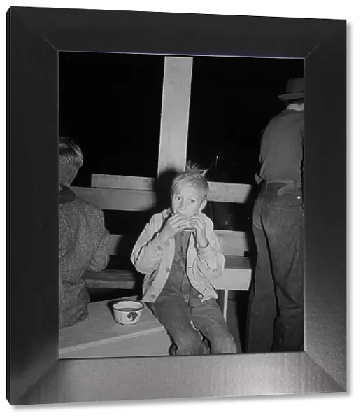Hungry boy at the Halloween party for migrant workers, Shafter migrant camp, California, 1938. Creator: Dorothea Lange