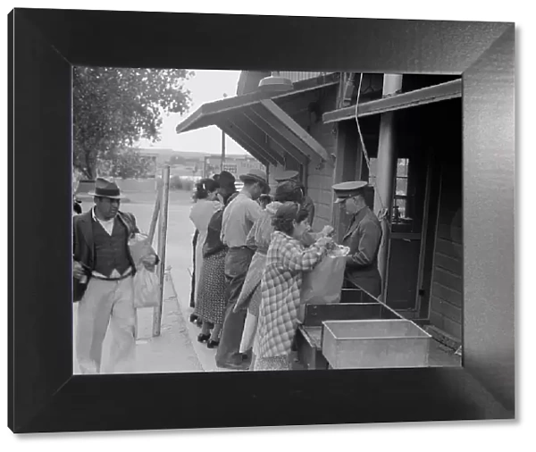 Plant quarantine inspectors examining packages brought over the bridge... Texas, 1937. Creator: Dorothea Lange