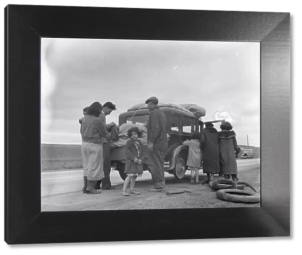 Migrants, family of Mexicans, on road with tire trouble, looking for work...California, 1936. Creator: Dorothea Lange