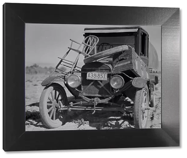 Car of drought refugee on edge of carrot field in the Coachella Valley, California, 1937. Creator: Dorothea Lange