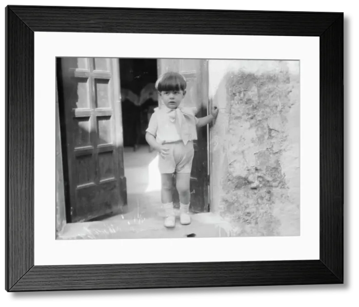 Framed Print : Cenerini, Mr. child of, standing in a doorway, 1929 Creator: Arnold Genthe Framed Print : Cenerini, Mr. child of, standing in a doorway, 1929 Creator: Arnold Genthe
