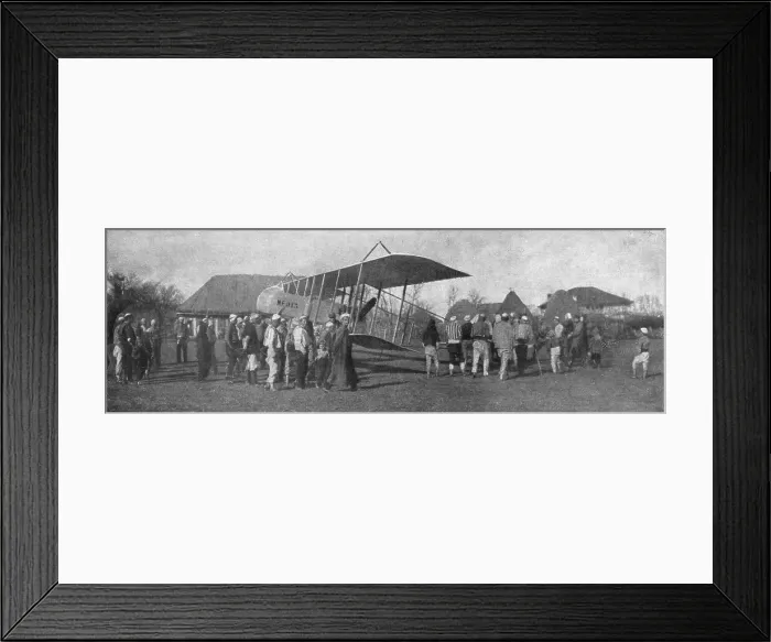 Framed Print : La retraite de nos aviateurs par l'Albanie; Biplan entoure par la population masculine... 1916. Creator: Unknown