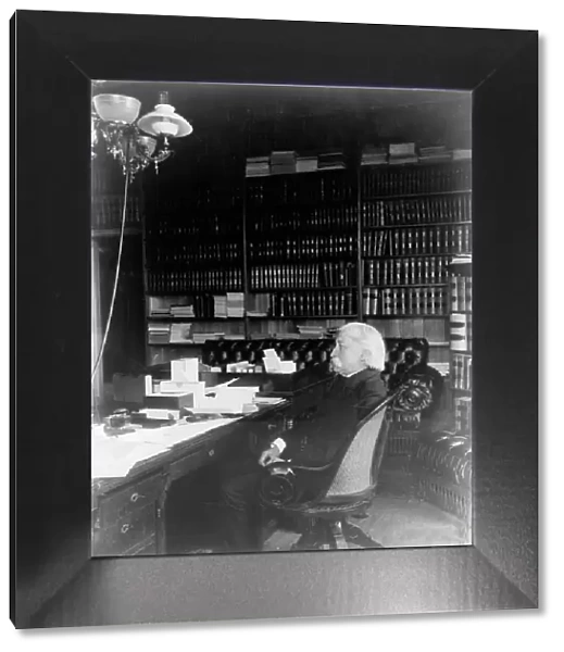 Melville Weston Fuller, full-length portrait, seated at desk, facing left, c1899. Creator: Frances Benjamin Johnston