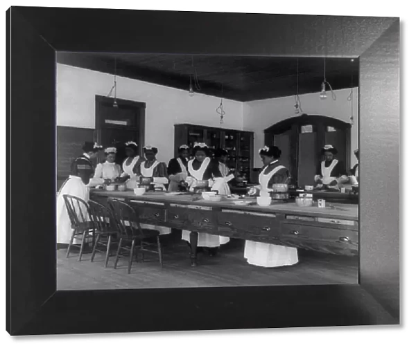 Ten Afro-American women in cooking class at Hampton Institute, Hampton, Va. between 1899 and 1900. Creator: Frances Benjamin Johnston