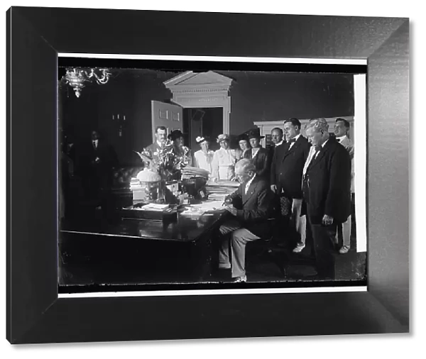 Woodrow Wilson signing Child Labor Bill, 1916. Creator: Harris & Ewing. Woodrow Wilson signing Child Labor Bill, 1916. Creator: Harris & Ewing