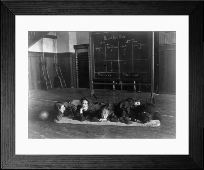 Framed Print : Five girls lying on mat in gymnasium in front of basketball scoreboard... Washington, D.C. (1899?) Creator: Frances Benjamin Johnston Framed Print : Five girls lying on mat in gymnasium in front of basketball scoreboard... Washington, D.C. (1899?) Creator: Frances Benjamin Johnston