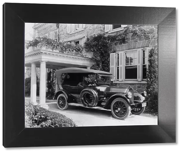 Automobile owned by Mrs. Charles W. Richardson in driveway with driver at the...Washington DC, c1919 Creator: Frances Benjamin Johnston