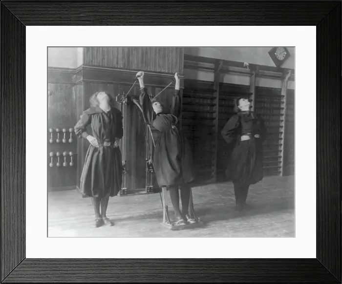 Framed Print : Female students exercising, one with a wall-mounted device using ropes... Washington, D.C. (1899?) Creator: Frances Benjamin Johnston Framed Print : Female students exercising, one with a wall-mounted device using ropes... Washington, D.C. (1899?) Creator: Frances Benjamin Johnston