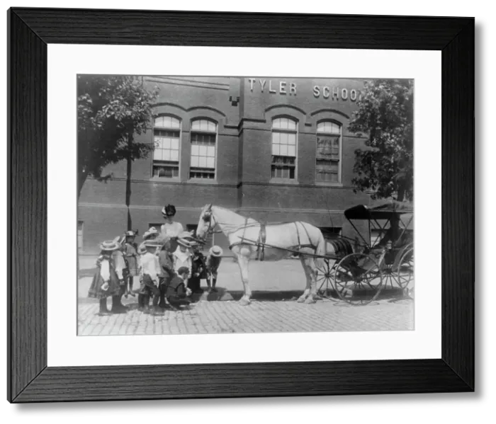 Framed Print : Children studying a horse and buggy outside the Tyler School, Washington, D.C. (1899?). Creator: Frances Benjamin Johnston Framed Print : Children studying a horse and buggy outside the Tyler School, Washington, D.C. (1899?). Creator: Frances Benjamin Johnston