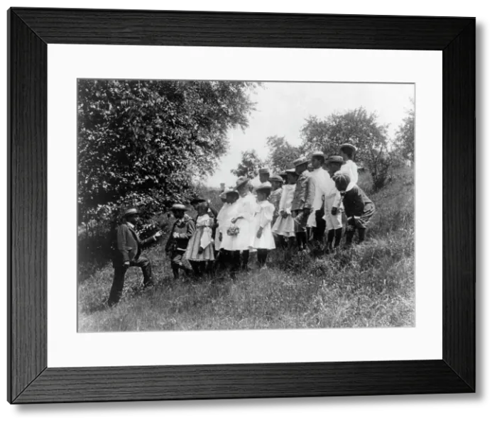 Framed Print : Field-trip - school children outdoors listening to man, DC Public School, 8th Division (?), (1899?). Creator: Frances Benjamin Johnston Framed Print : Field-trip - school children outdoors listening to man, DC Public School, 8th Division (?), (1899?). Creator: Frances Benjamin Johnston