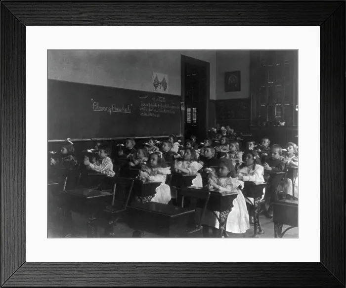 Framed Print : Children in a classroom blowing pinwheels in a Washington, D.C. grade school, (1899?). Creator: Frances Benjamin Johnston Framed Print : Children in a classroom blowing pinwheels in a Washington, D.C. grade school, (1899?). Creator: Frances Benjamin Johnston