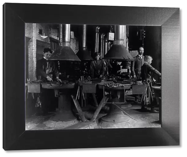 Metal shop (blacksmithing) class in a Washington, D.C. high school, (1899?). Creator: Frances Benjamin Johnston