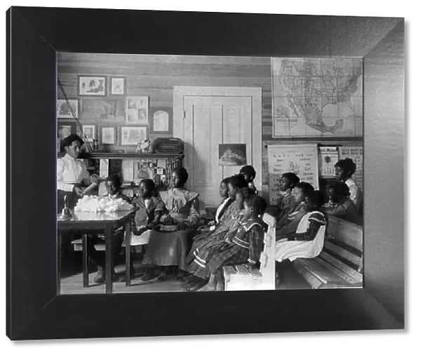 African American children and teacher in classroom studying... Annie Davis School...Alabama, c1902. Creator: Frances Benjamin Johnston