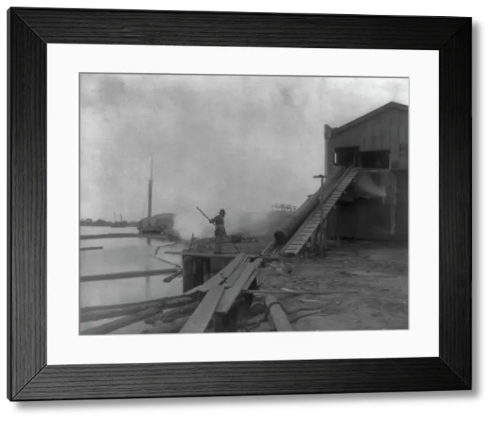 Framed Print : African American guiding log from water onto saw mill ramp, Newport News, Va. 1900, 1899 or 1900. Creator: Frances Benjamin Johnston Framed Print : African American guiding log from water onto saw mill ramp, Newport News, Va. 1900, 1899 or 1900. Creator: Frances Benjamin Johnston
