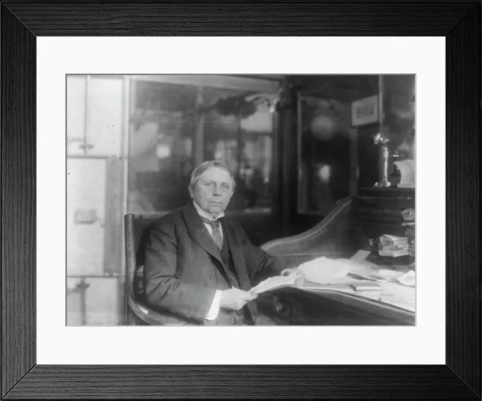 Framed Print : Man (banker?) seated at desk at American Security and Trust Co. Washington, D.C. c1890 - c1950. Creator: Frances Benjamin Johnston Framed Print : Man (banker?) seated at desk at American Security and Trust Co. Washington, D.C. c1890 - c1950. Creator: Frances Benjamin Johnston