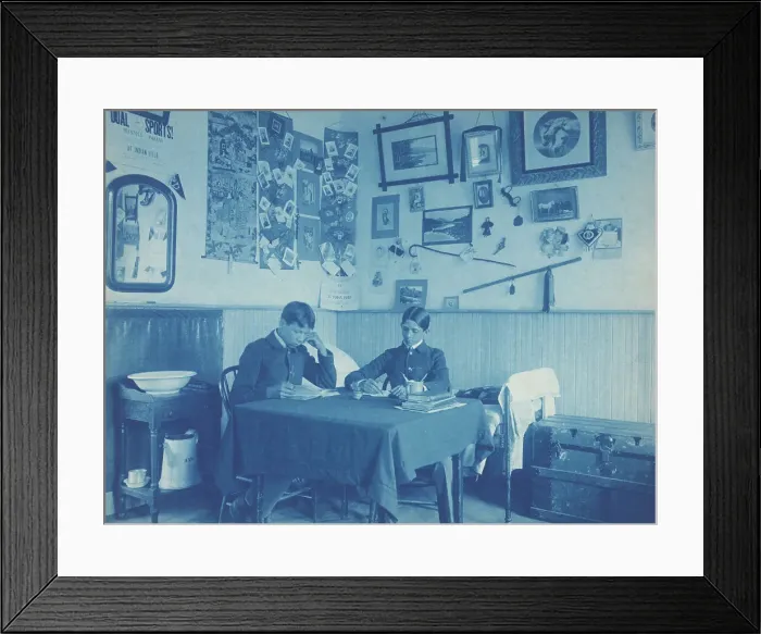 Framed Print : Carlisle Indian School, Carlisle, Pa. Two boys studying in dormitory room, 1901. Creator: Frances Benjamin Johnston Framed Print : Carlisle Indian School, Carlisle, Pa. Two boys studying in dormitory room, 1901. Creator: Frances Benjamin Johnston