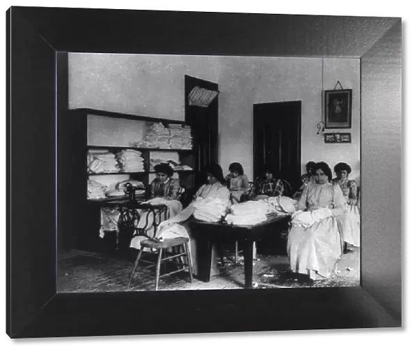 Carlisle Indian School, Carlisle, Pa. Clothes mending class, 1901. Creator: Frances Benjamin Johnston