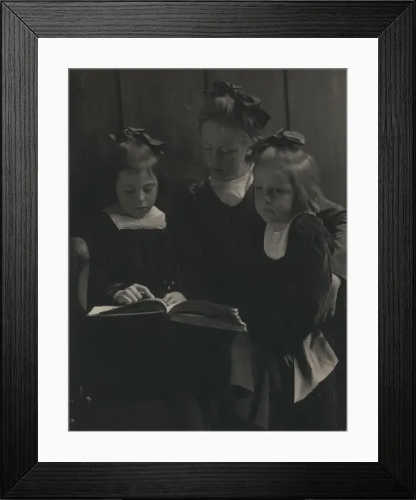 Framed Print : Three young girls reading a book, c1900. Creator: Gertrude Kasebier