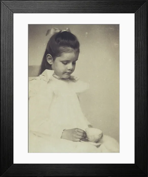 Framed Print : Young girl in white dress, seated holding teacup and saucer, c1900. Creator: Anne K Pilsbury Framed Print : Young girl in white dress, seated holding teacup and saucer, c1900. Creator: Anne K Pilsbury