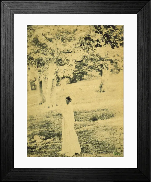 Framed Print : Woman standing in a park, trees in background, c1900. Creator: Eva Watson-Schutze