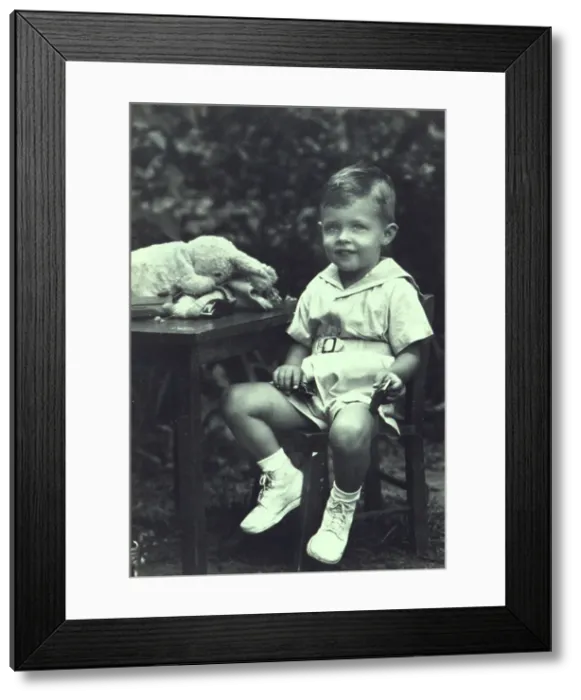 Framed Print : Portrait of a young boy seated at an outdoor table, facing front, between 1940 and 1950. Creator: Joseph Woodson Whitesell Framed Print : Portrait of a young boy seated at an outdoor table, facing front, between 1940 and 1950. Creator: Joseph Woodson Whitesell