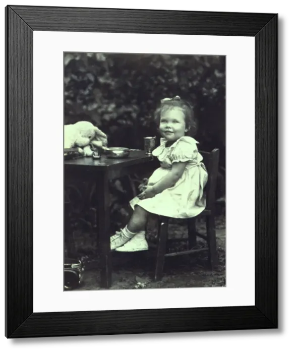 Framed Print : Portrait of a young girl seated at an outdoor table, facing front, between 1940 and 1950. Creator: Joseph Woodson Whitesell Framed Print : Portrait of a young girl seated at an outdoor table, facing front, between 1940 and 1950. Creator: Joseph Woodson Whitesell