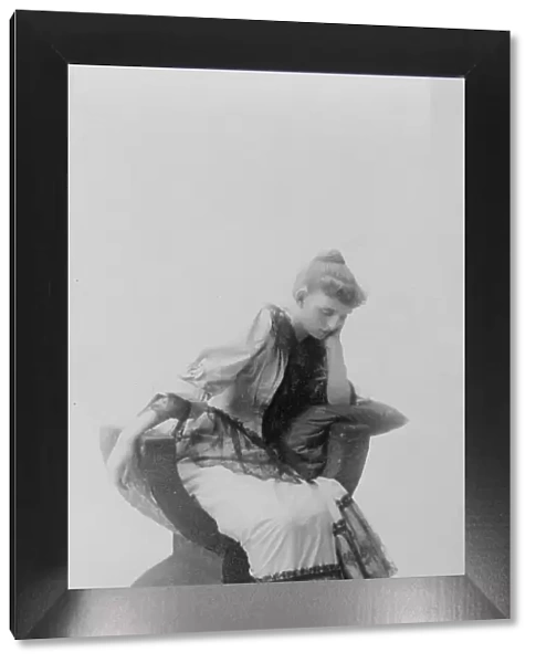 Frances Benjamin Johnston, full-length portrait, seated, facing left, looking... c1880 - 1890. Creator: Unknown