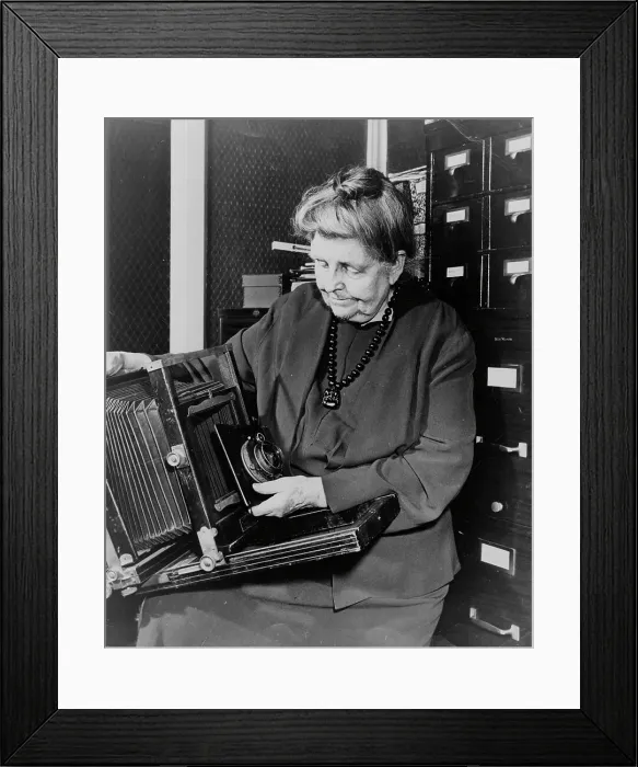 Framed Print : Frances Benjamin Johnston, three-quarter length portrait, holding and looking down... c1950. Creator: Unknown Framed Print : Frances Benjamin Johnston, three-quarter length portrait, holding and looking down... c1950. Creator: Unknown