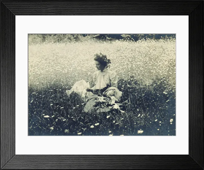 Framed Print : Woman with wreath of leaves in her hair sitting in a field of daisies, c1900. Creator: Unknown Framed Print : Woman with wreath of leaves in her hair sitting in a field of daisies, c1900. Creator: Unknown